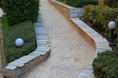 View of beautiful stone pathway near green plants outdoors