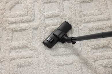 Photo of Hoovering carpet with vacuum cleaner, above view