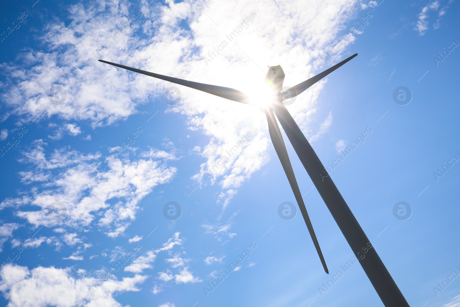 Photo of Wind turbine against beautiful blue sky, low angle view. Alternative energy source