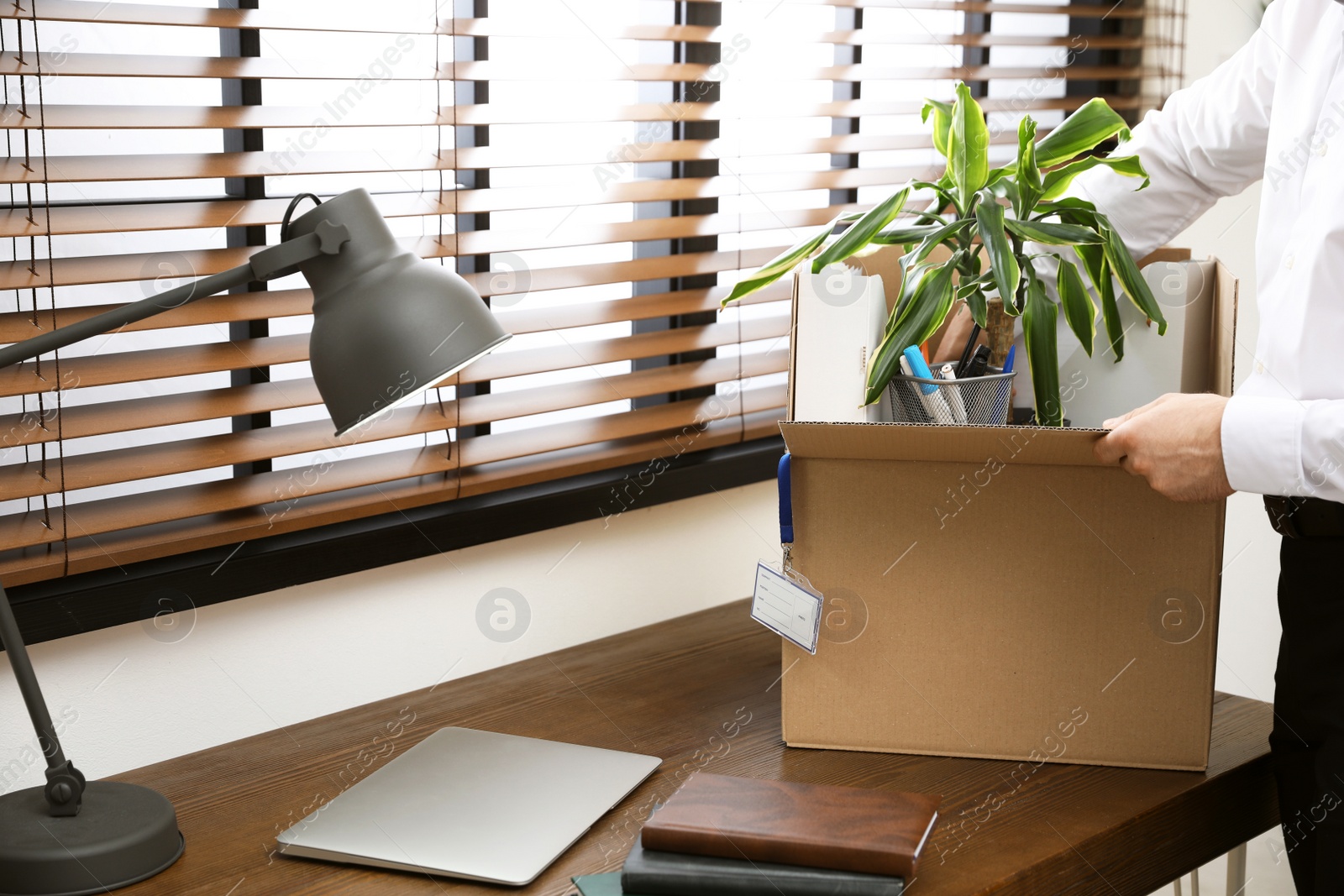 Photo of Businessman with moving box in office, closeup. Work promotion concept