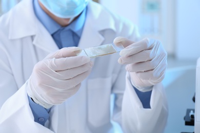 Photo of Young scientist working in laboratory, closeup. Chemical analysis