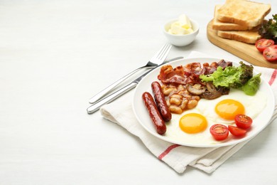 Delicious breakfast with sunny side up eggs served on white table. Space for text