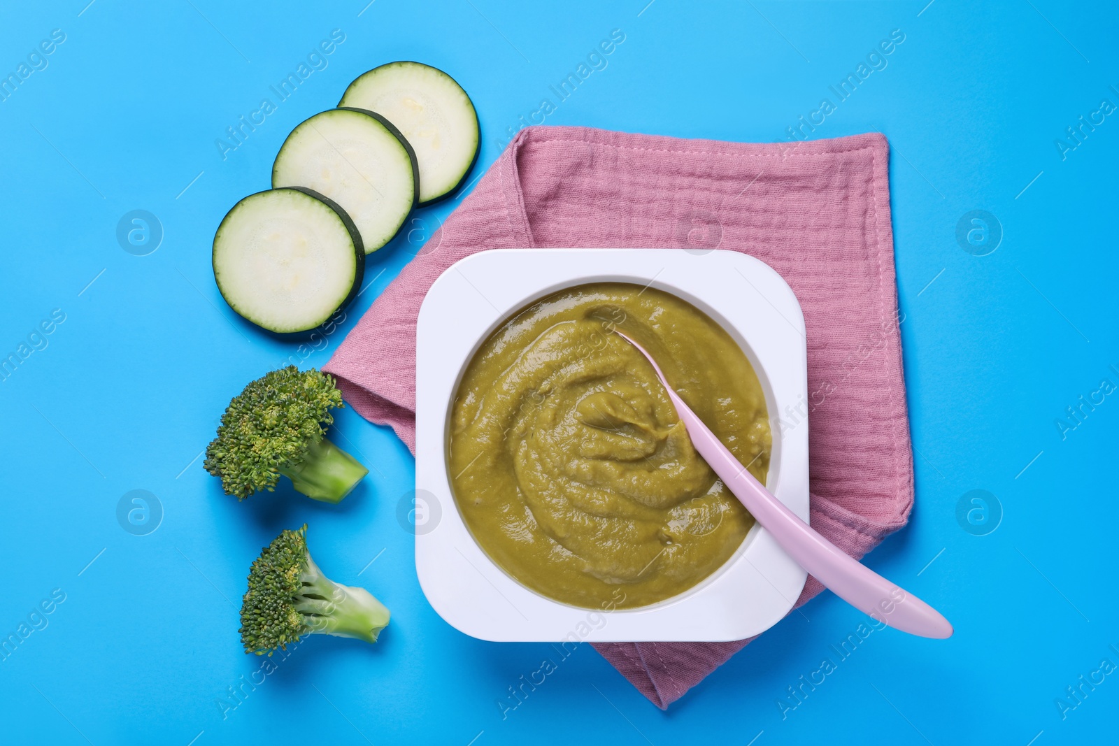 Photo of Healthy baby food and vegetables on light blue background, flat lay