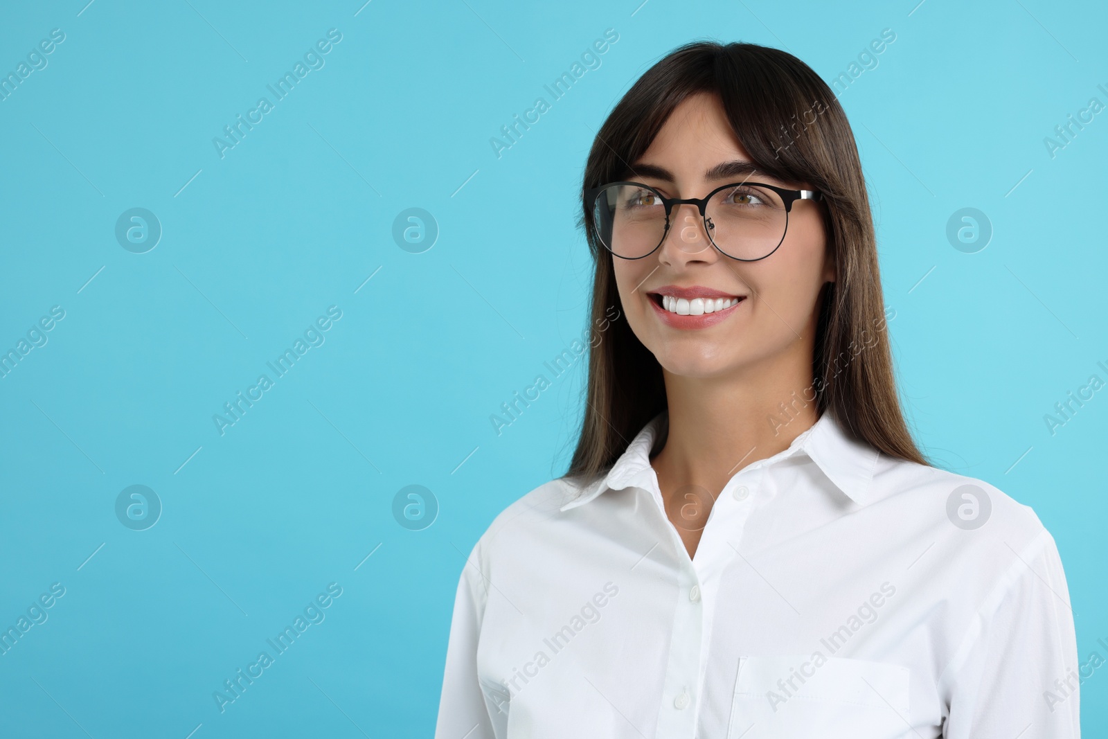 Photo of Portrait of happy secretary on light blue background. Space for text