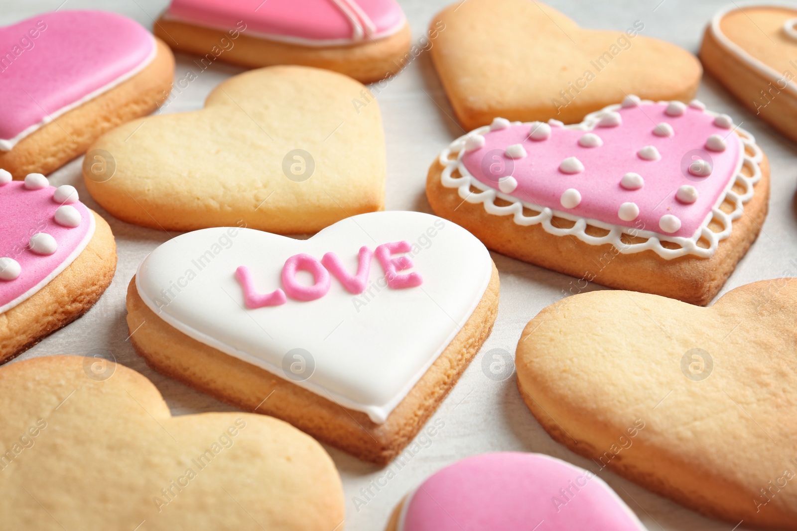 Photo of Decorated heart shaped cookies on table. Valentine's day treat