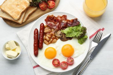 Delicious breakfast with sunny side up eggs served on white table, flat lay