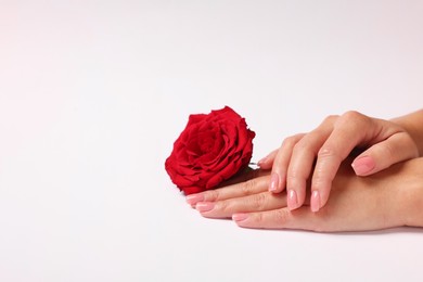 Photo of Woman with red rose on white background, closeup. Space for text