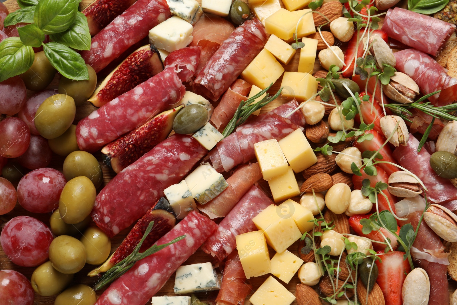 Photo of Different tasty appetizers as background, top view