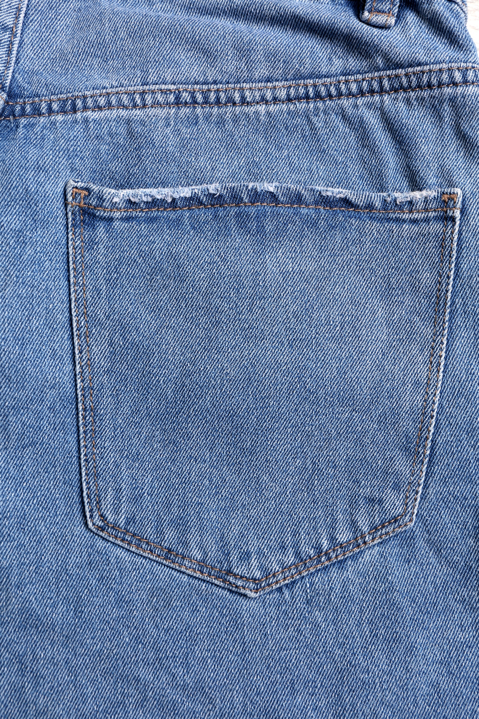 Photo of Light blue jeans with back pocket as background, closeup