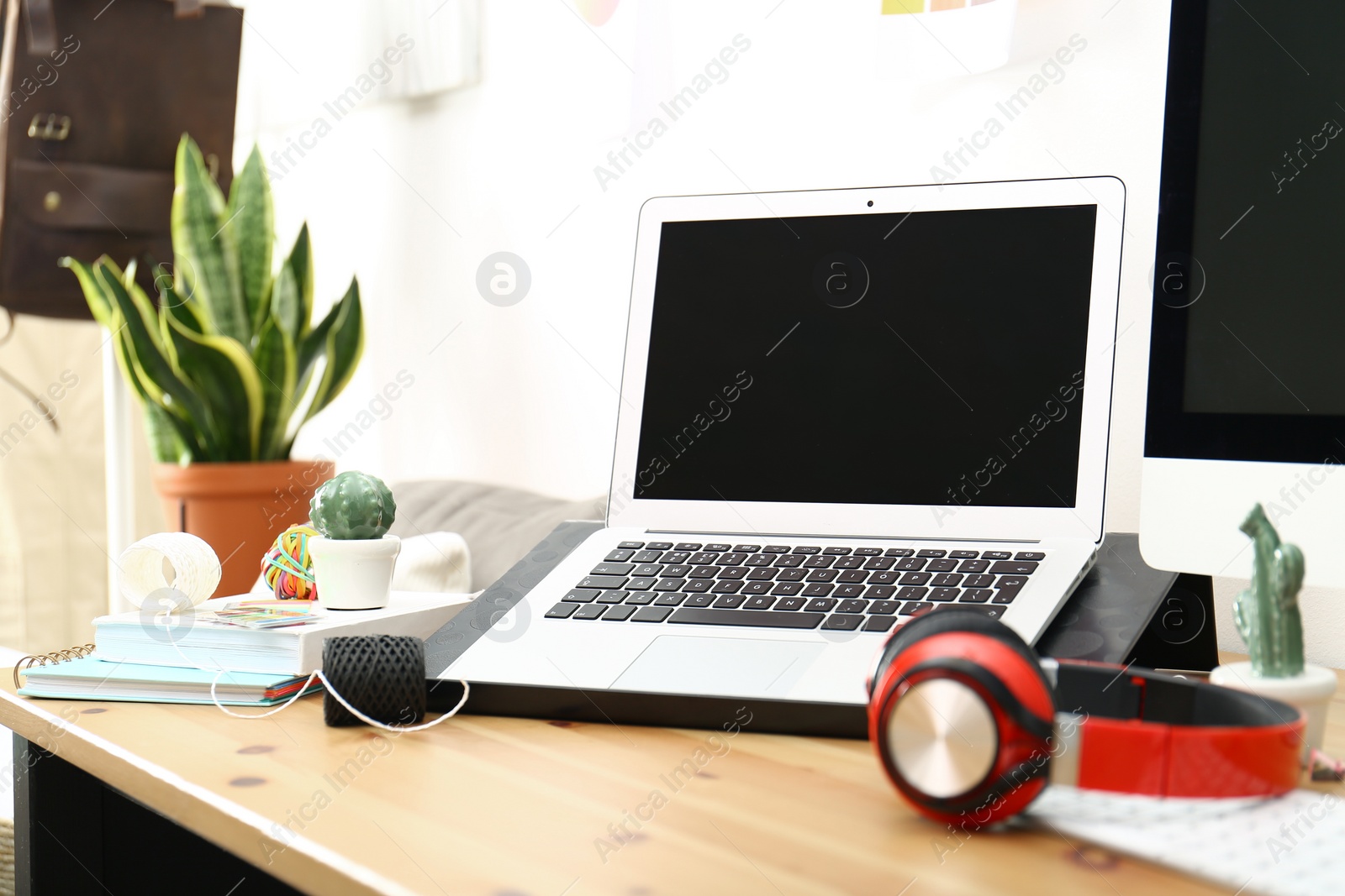 Photo of Modern laptop, computer and office supplies on wooden table, space for text. Designer's workplace