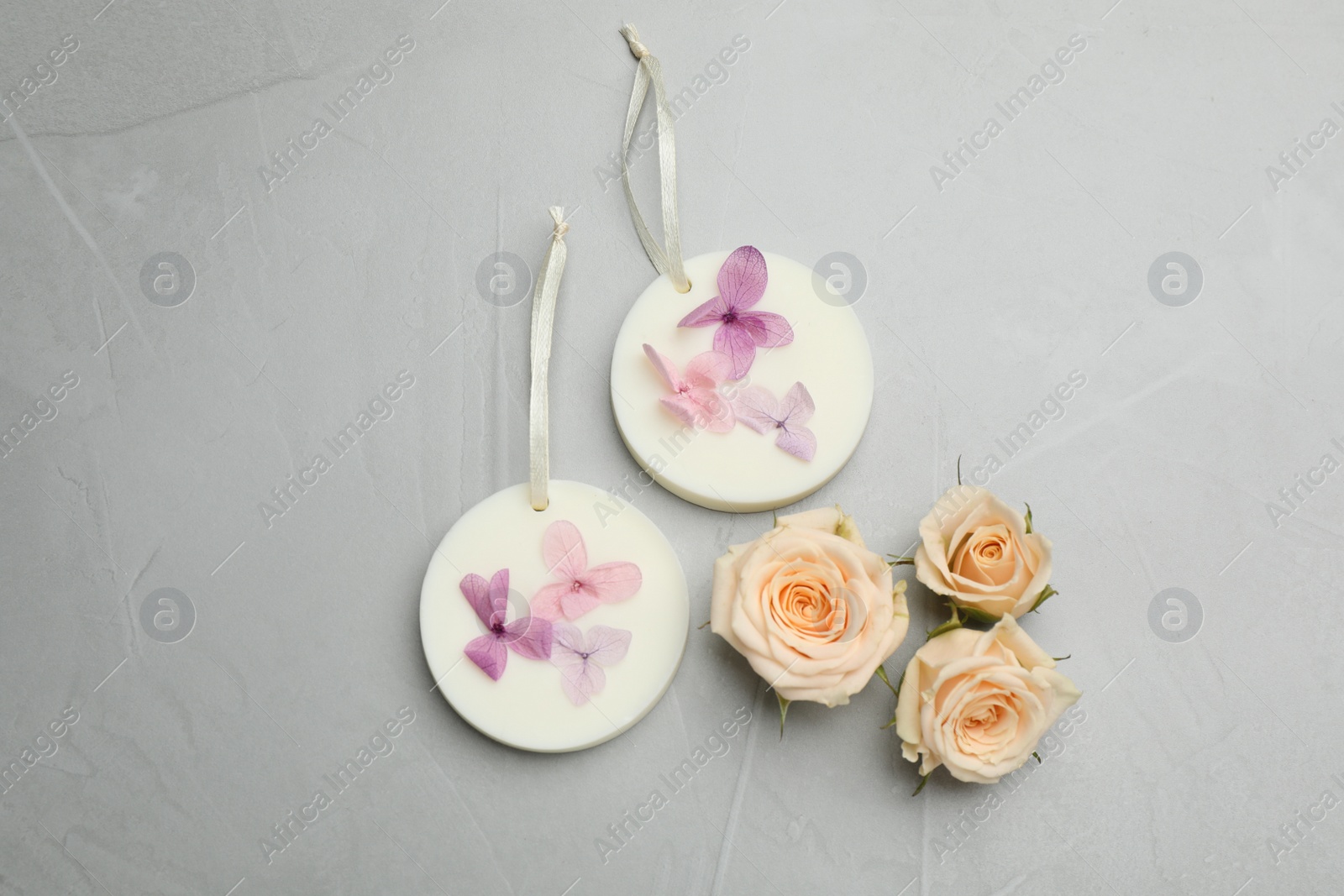 Photo of Flat lay composition with scented sachets on light grey table