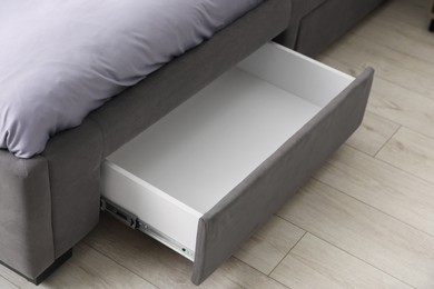 Photo of Storage drawer for bedding under modern bed in room