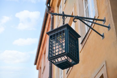 Photo of Beautiful vintage street lamp hanging on wall of building