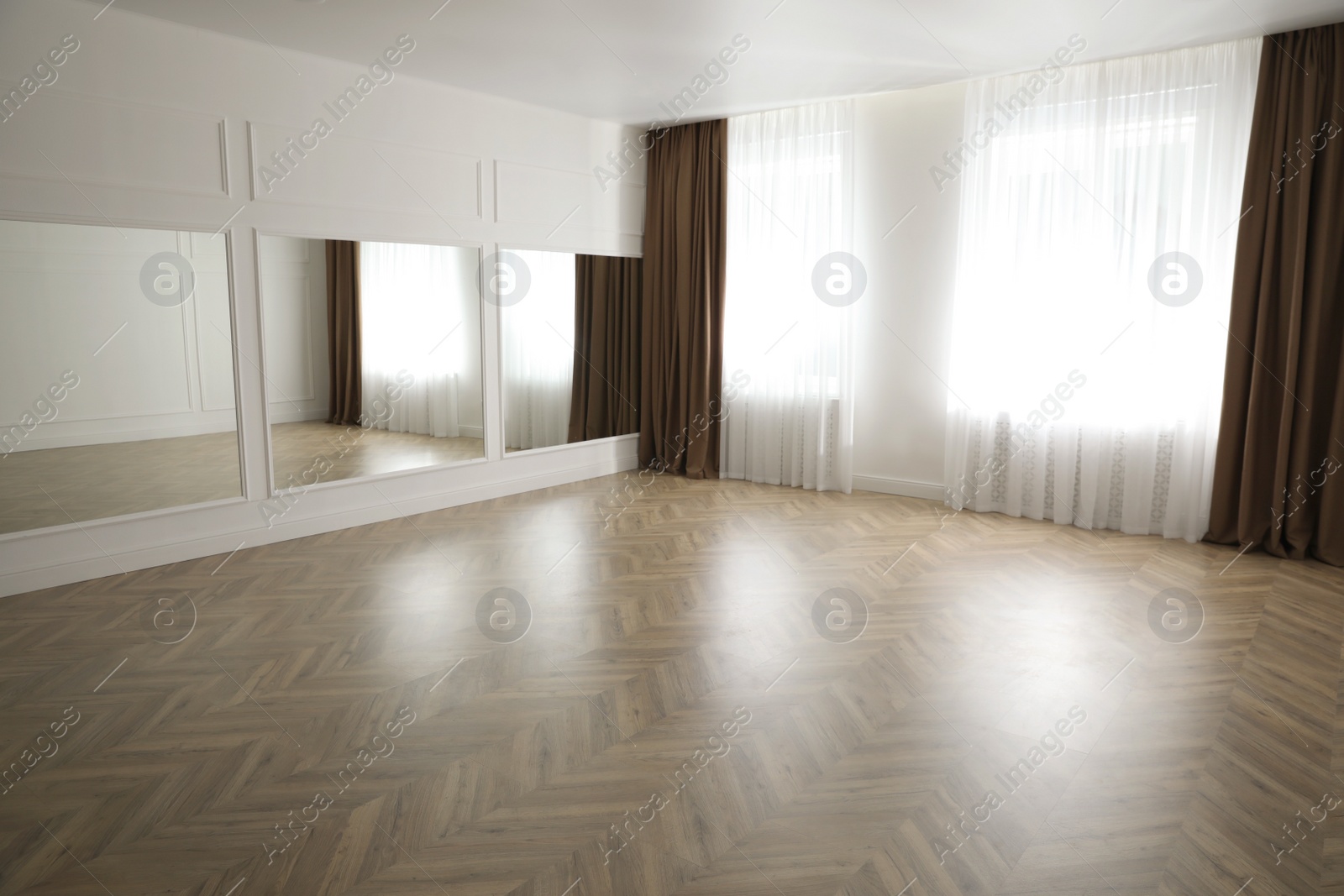 Photo of Parquet floor in light spacious empty room