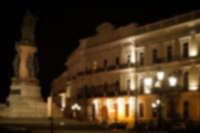 Blurred view of street with lights at night. Bokeh effect