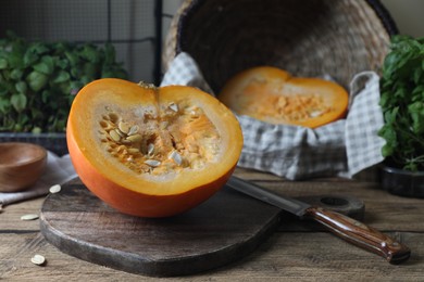 Photo of Cut fresh ripe pumpkin on wooden table, space for text