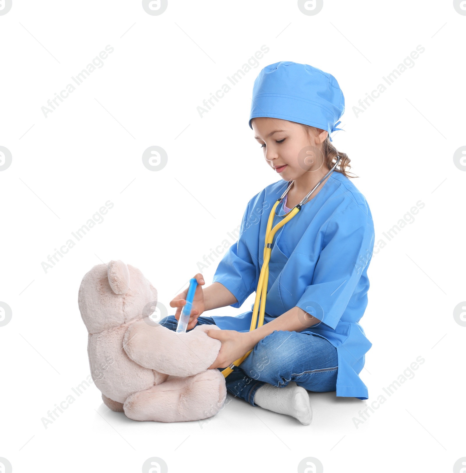 Photo of Cute child playing doctor with stuffed toy on white background