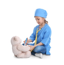 Cute child playing doctor with stuffed toy on white background