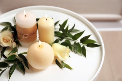 Photo of Beautiful composition with burning candles and flowers on table