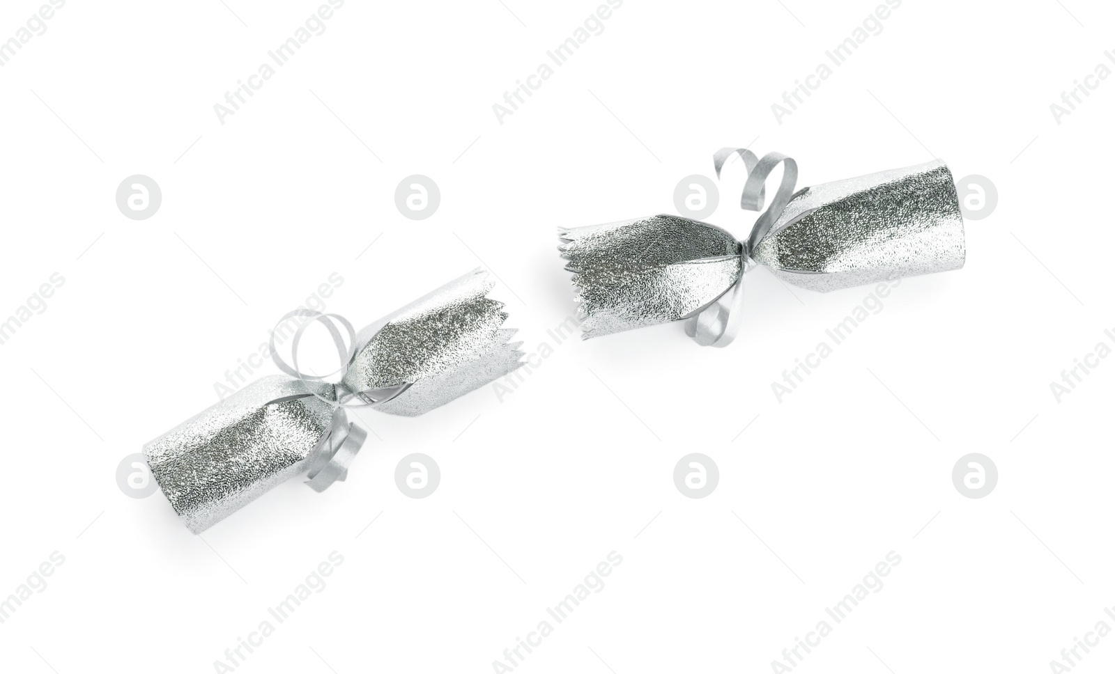 Photo of Open silver Christmas cracker isolated on white, top view