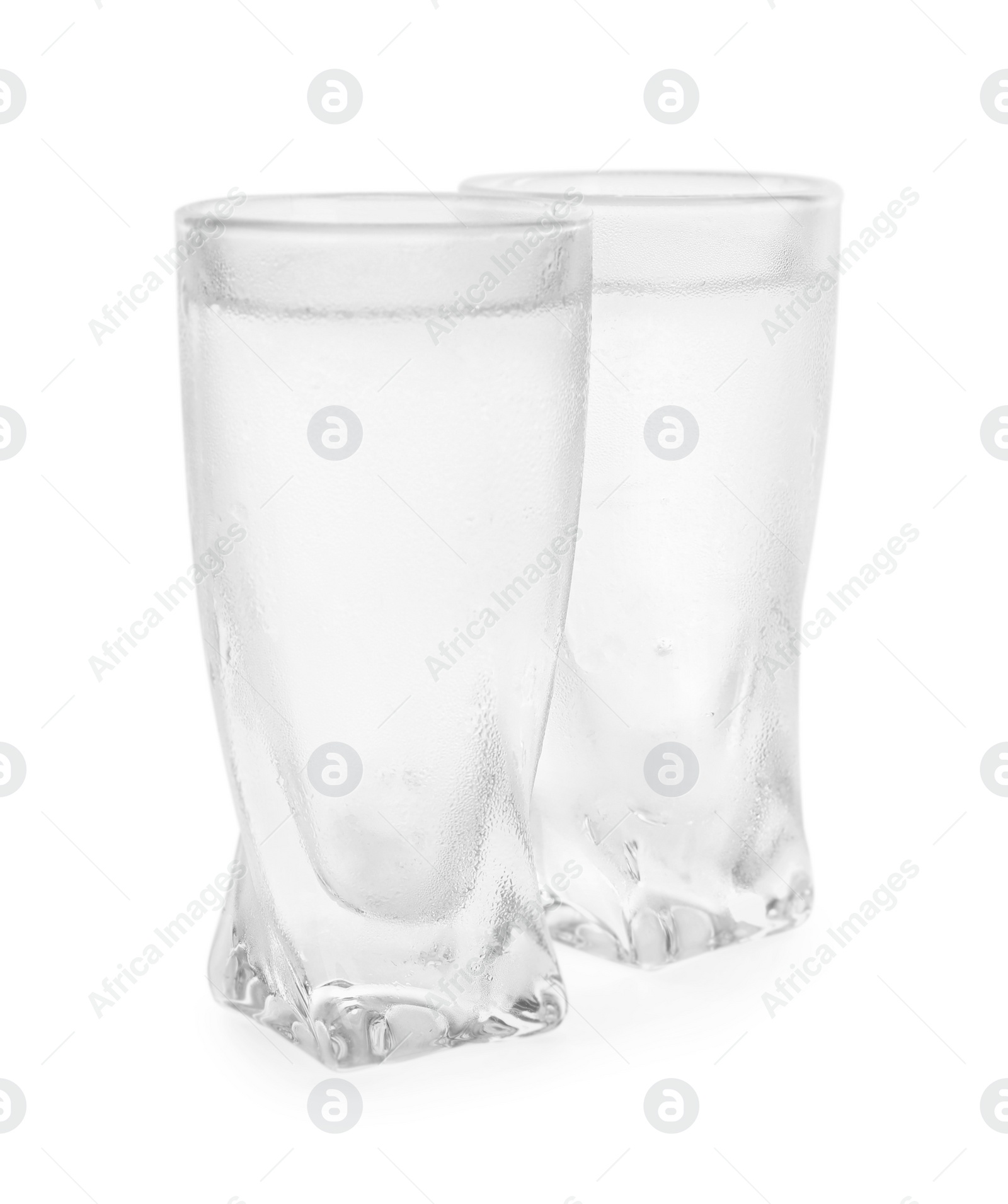 Photo of Vodka in shot glasses on white background