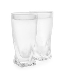 Vodka in shot glasses on white background