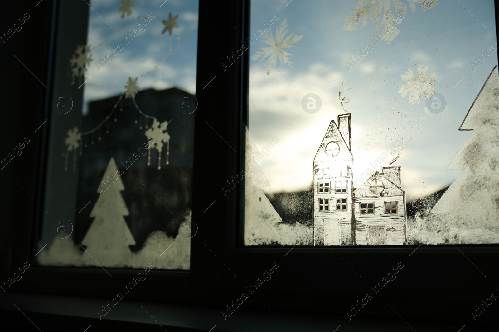 Photo of Beautiful drawing made with artificial snow on window. Christmas decor