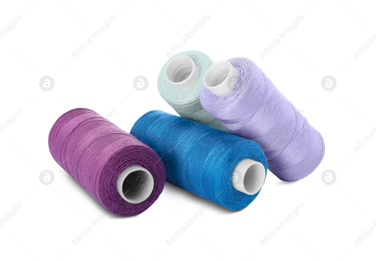 Photo of Many different colorful sewing threads on white background