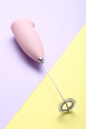 Photo of Pink milk frother wand on color background