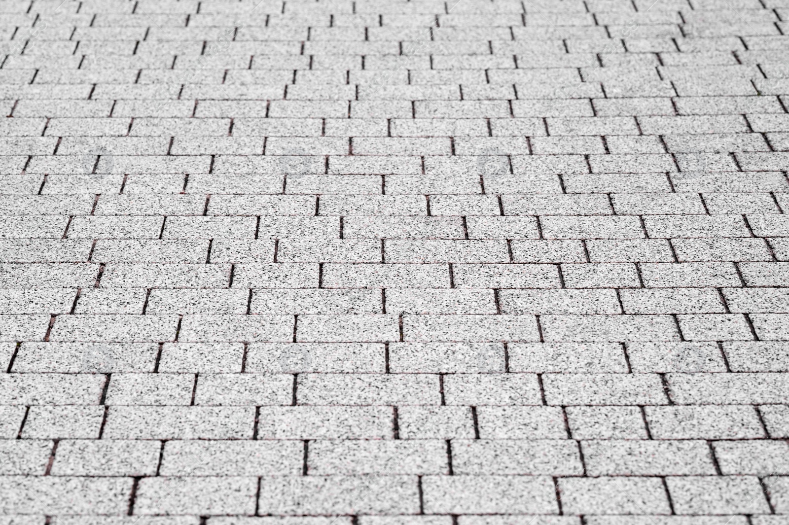 Photo of View on white stone sidewalk, top view. Footpath covering