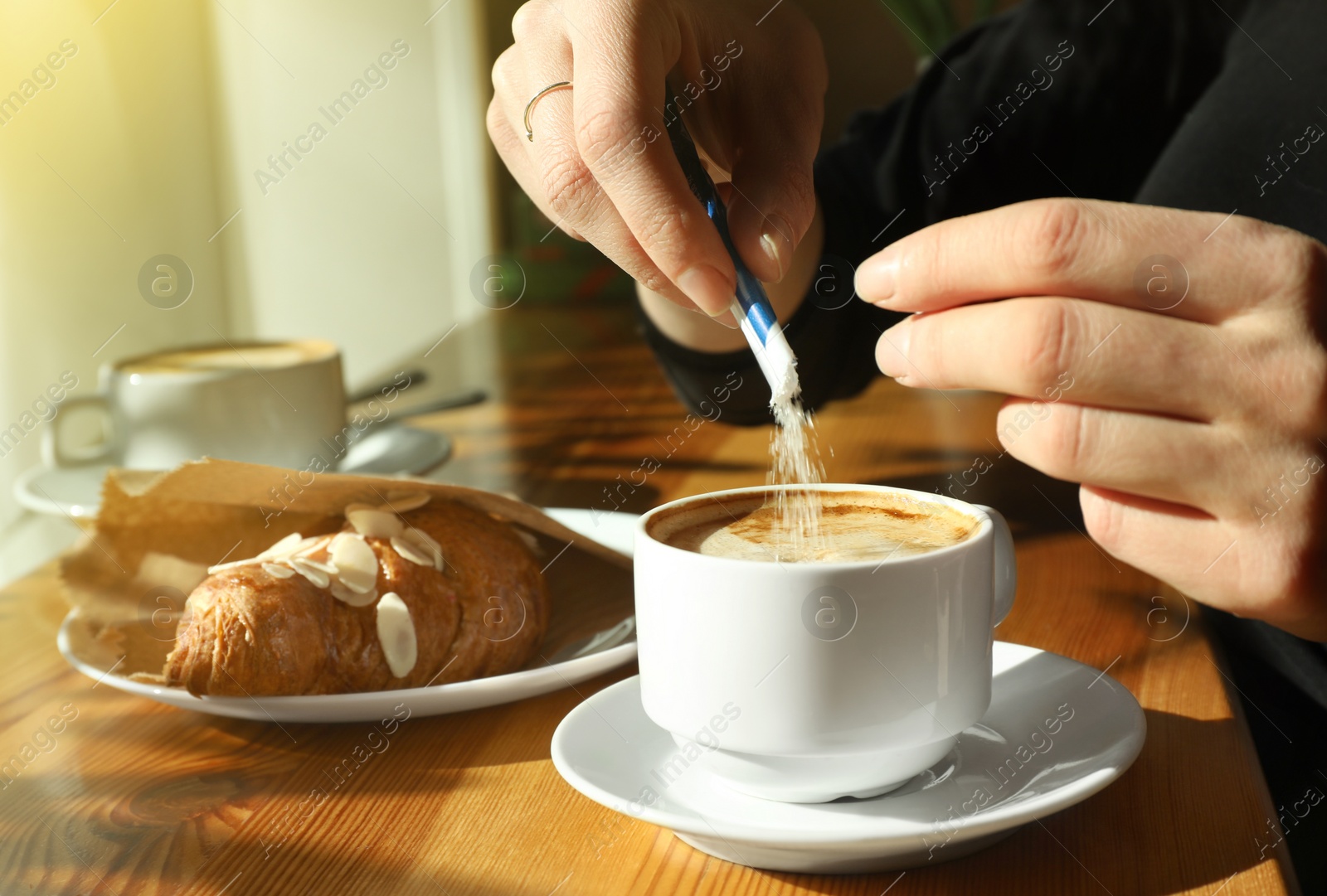 Photo of Woman with cup of fresh aromatic coffee at table in cafe