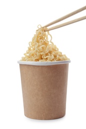 Photo of Paper cup of instant noodles and chopsticks isolated on white. Mockup for design