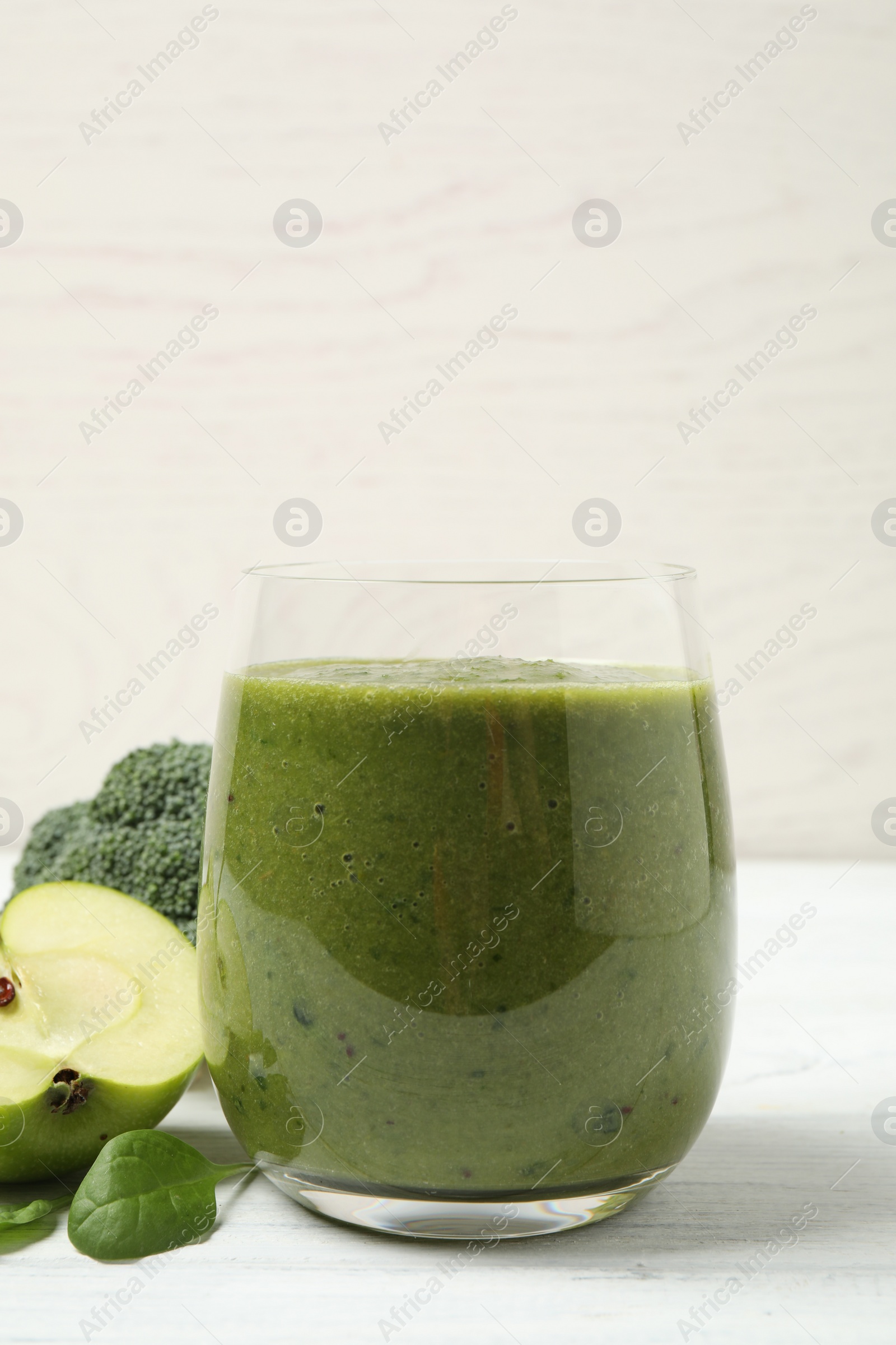 Photo of Delicious fresh green juice on white wooden table