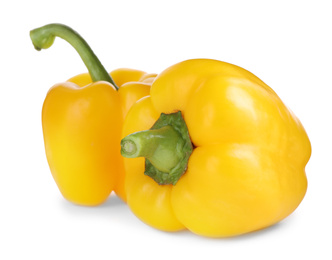 Photo of Ripe yellow bell peppers isolated on white