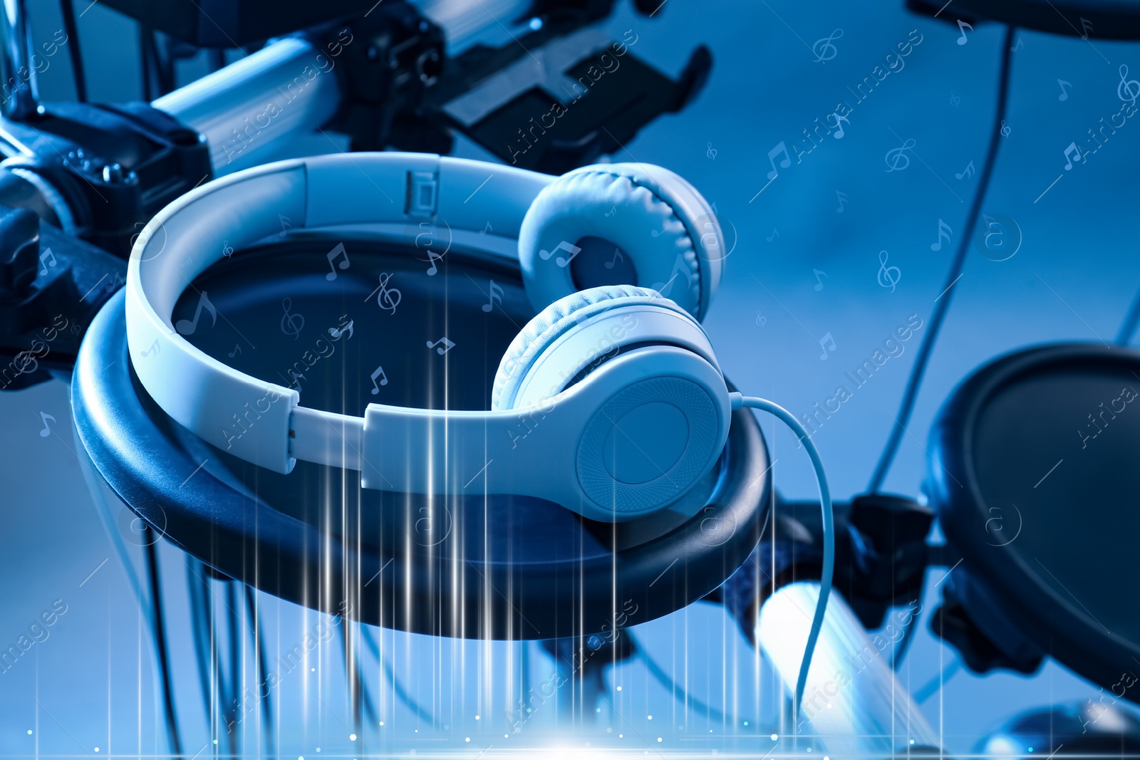 Image of Modern headphones with illustration musical notes on light background, toned in blue