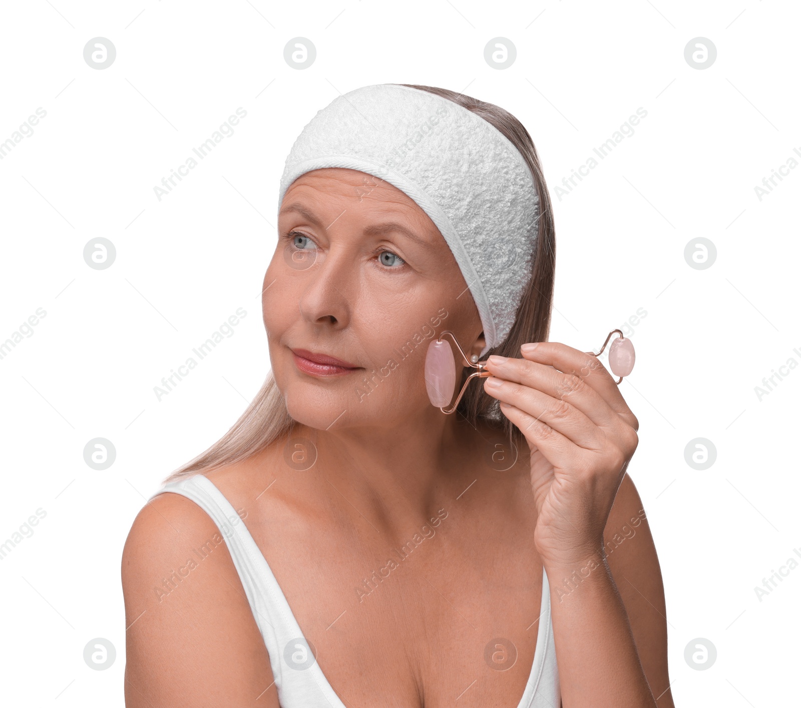 Photo of Woman massaging her face with rose quartz roller isolated on white