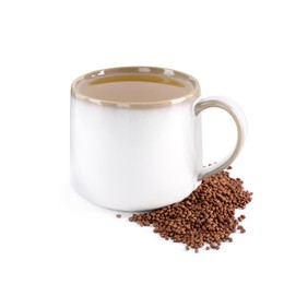 Cup of aromatic buckwheat tea and granules on white background