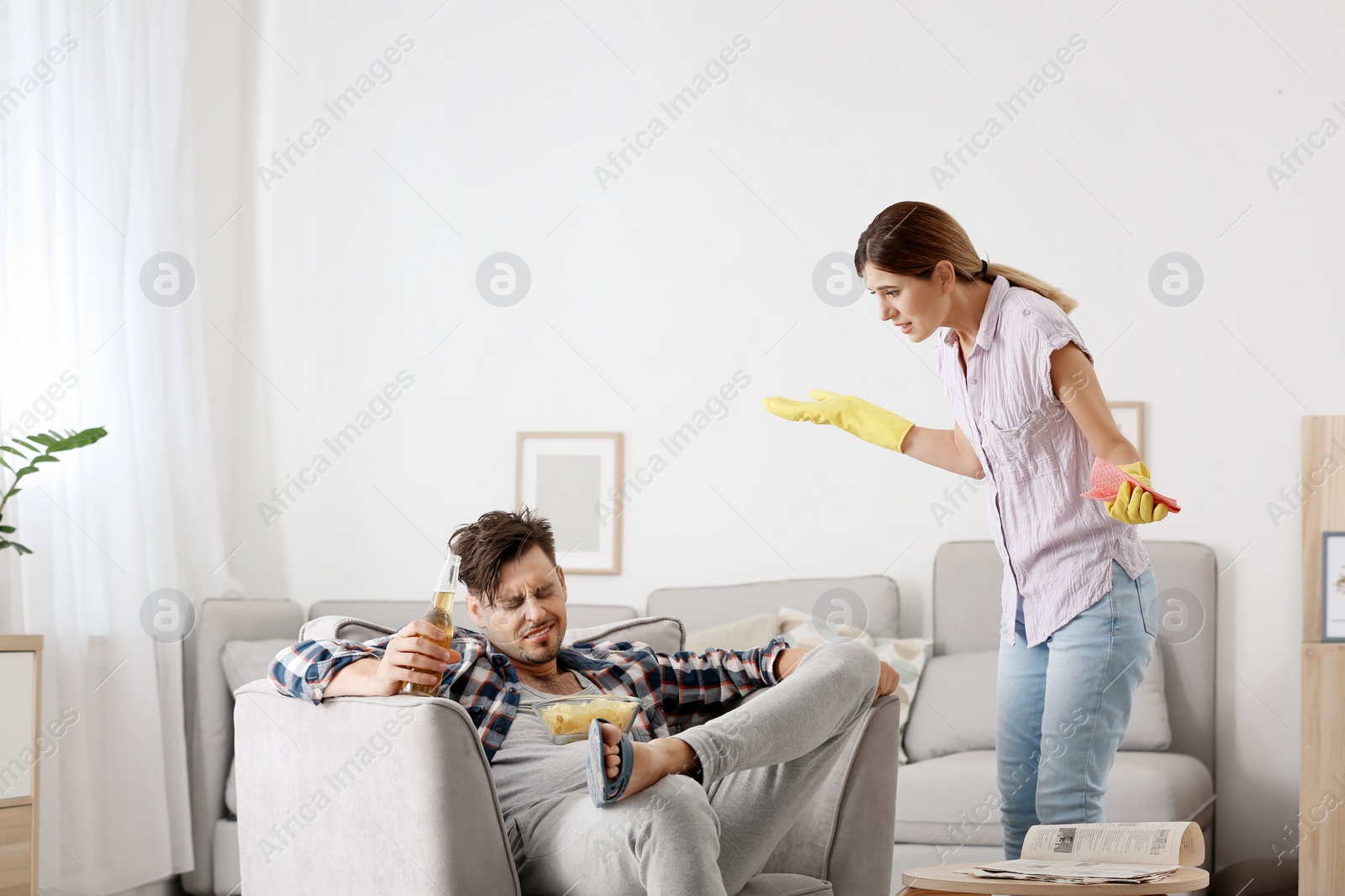 Photo of Lazy husband quarrelling with hardworking wife at home