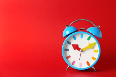 Photo of Alarm clock on color background. Time change concept