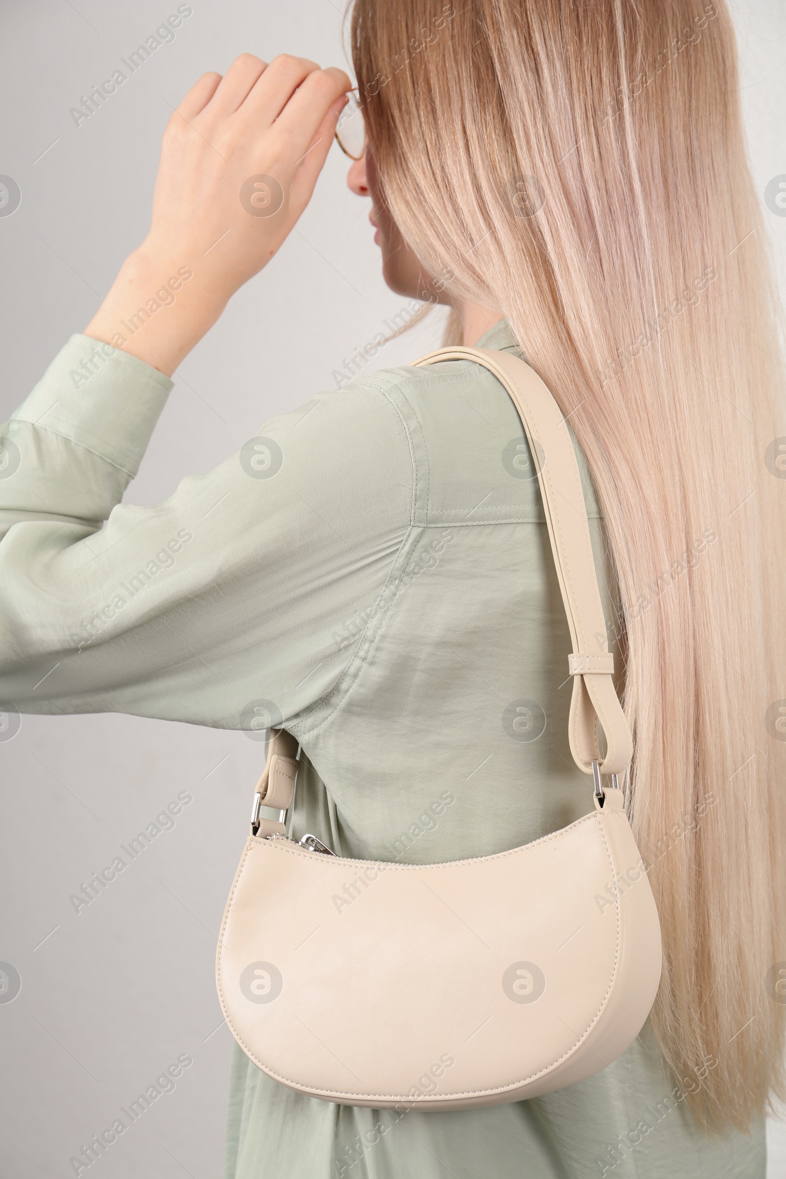 Photo of Woman with stylish baguette handbag on white background