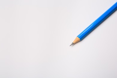 Sharp graphite pencil on white background, top view. Space for text