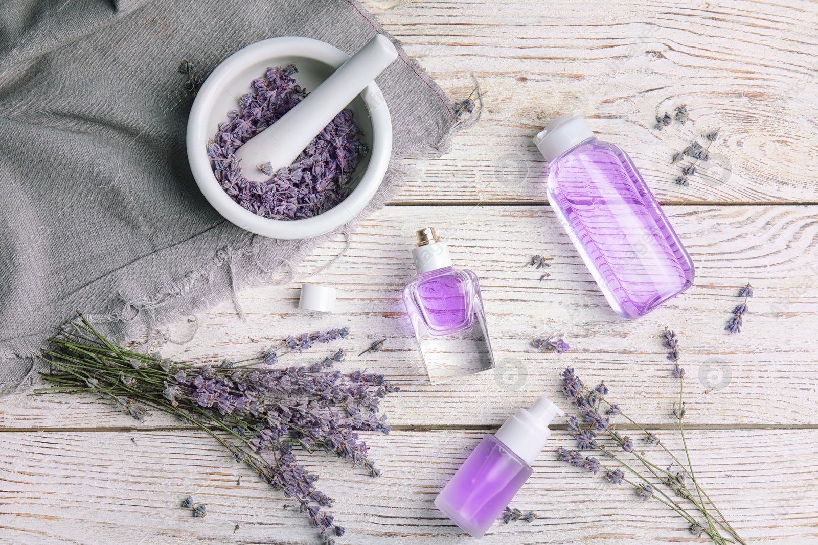 Photo of Flat lay composition with lavender flowers and natural cosmetic on wooden background