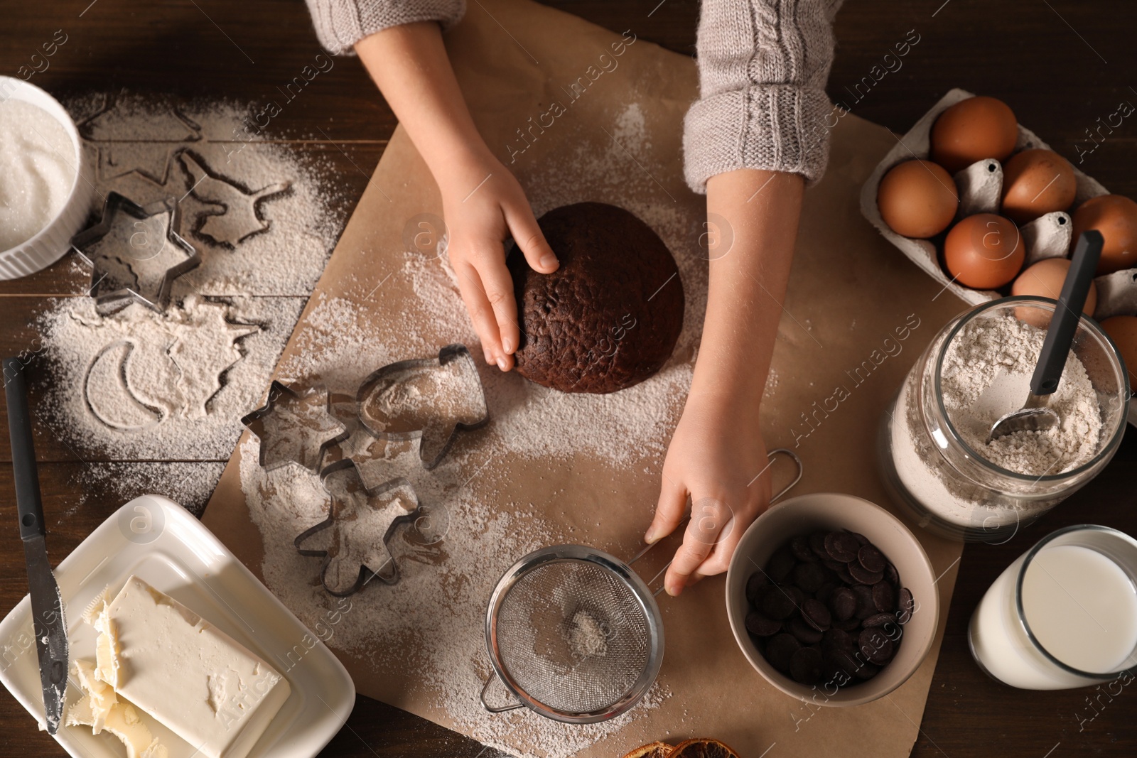 Photo of Little child making Christmas cookies at wooden table, top view