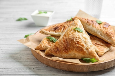 Photo of Fresh delicious puff pastry on white wooden table