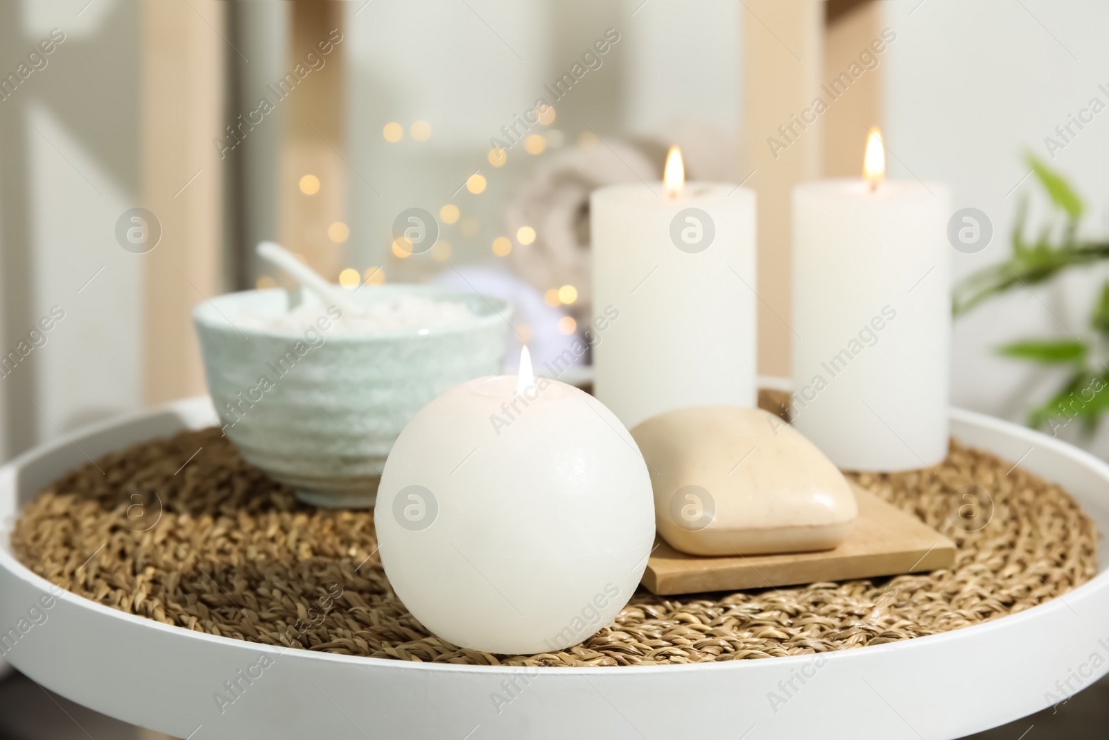 Photo of Beautiful spa composition with candles and cosmetic on table