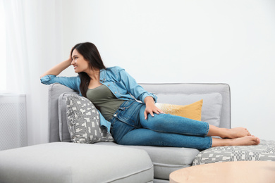 Young woman relaxing on couch at home