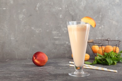 Glass with delicious milk shake on table