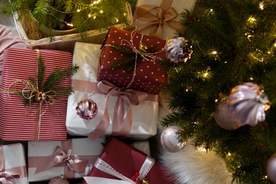 Photo of Gift boxes under Christmas tree, above view