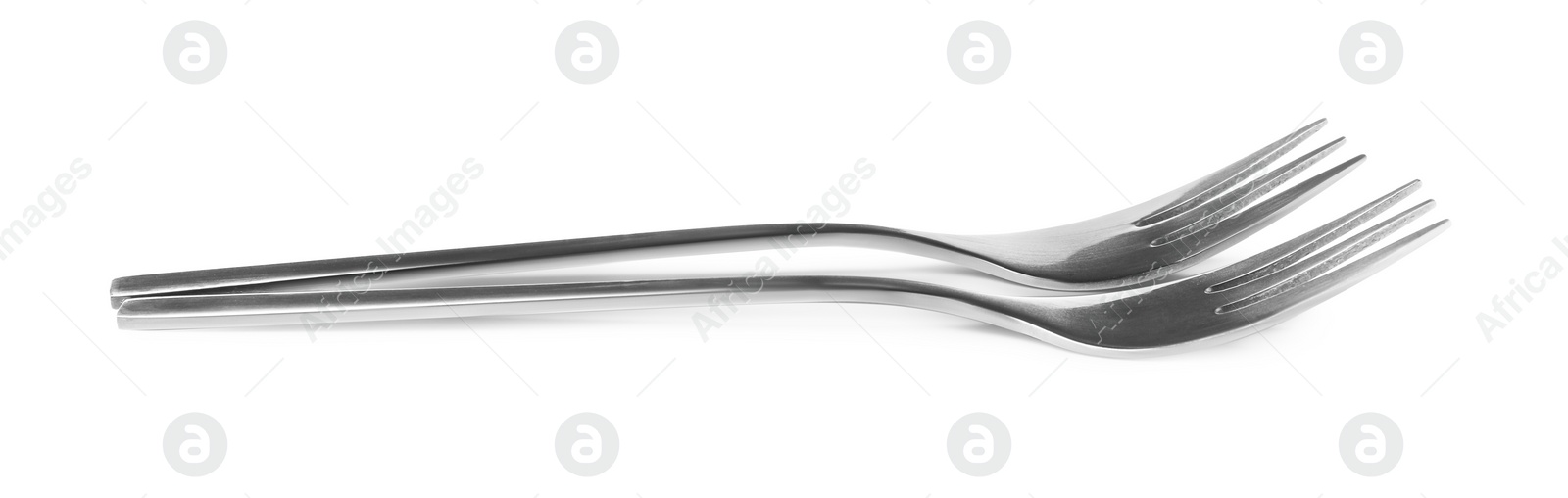 Photo of Clean shiny metal forks on white background