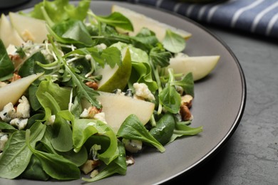 Tasty salad with pear slices on table, closeup